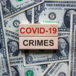 Dollar bills and wooden blocks saying COVID 19 crimes