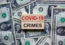 Dollar bills and wooden blocks saying COVID 19 crimes