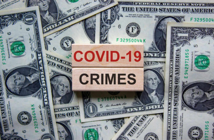 Dollar bills and wooden blocks saying COVID 19 crimes