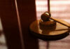 Gavel on a wooden table in sunlight