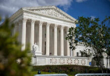 Retirement Rumors Swirl—Who’s Leaving the Bench? Large neoclassical building with columns behind trees