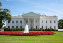 White House with fountain and red flowers