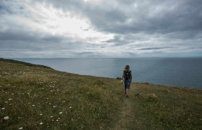 woman-enjoys-a-walk-on-coast2298561527jpg