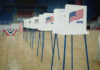 Voting booths lined up in a gymnasium.
