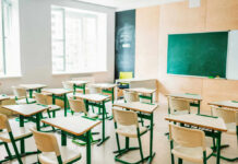 Empty classroom with desks facing a chalkboard