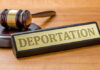 Haitian Fraudster Caught – Faces Deportation Gavel and sign reading Deportation on desk.
