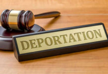 Gavel and sign reading Deportation on desk.