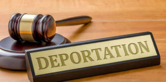 Gavel and sign reading Deportation on desk.