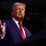 Man speaking at a podium with microphone