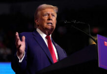 Man speaking at a podium with microphone