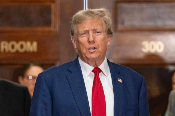 I dont know who this is. Man speaking, indoors, wearing suit.