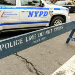 NYPD police barricade on city street with vehicles