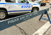 NYPD police barricade on city street with vehicles
