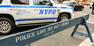 NYPD police barricade on city street with vehicles