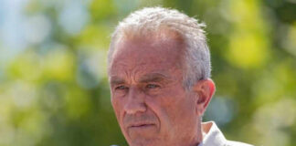 Man speaking into microphone at outdoor event