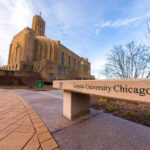 Sign for Loyola University Chicago with a building in the background