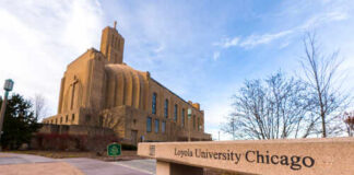 Sign for Loyola University Chicago with a building in the background