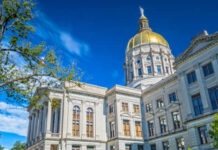 Historic government building with a golden dome under a blue sky