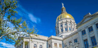 Historic government building with a golden dome under a blue sky