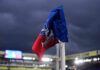 Corner flag of Crystal Palace F.C. at a stadium under dark clouds