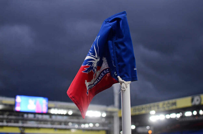 Corner flag of Crystal Palace F.C. at a stadium under dark clouds