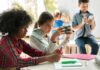 Children engaged with devices in a classroom