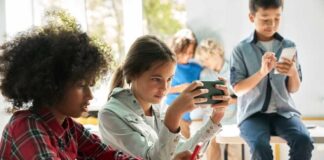 Children engaged with devices in a classroom