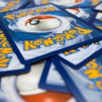 A pile of Pokémon trading cards featuring a Poké Ball design