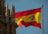 Spanish flag waving against a clear blue sky