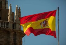 Spanish flag waving against a clear blue sky