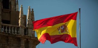 Spanish flag waving against a clear blue sky
