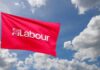 Red flag with 'Labour' text flying against a cloudy sky