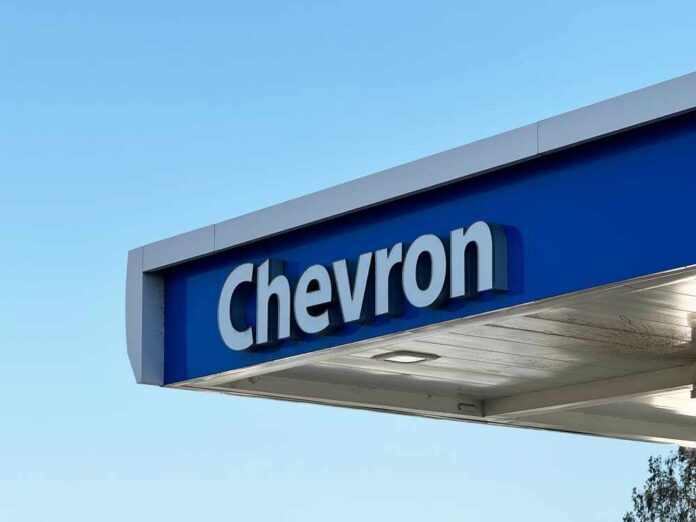 Chevron gas station sign against a clear blue sky