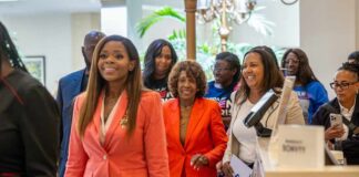 A diverse group of people smiling and walking together at an event