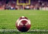 A close-up of a football on the grass field