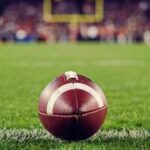 A close-up of a football on the grass field