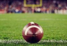 A close-up of a football on the grass field