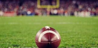 A close-up of a football on the grass field