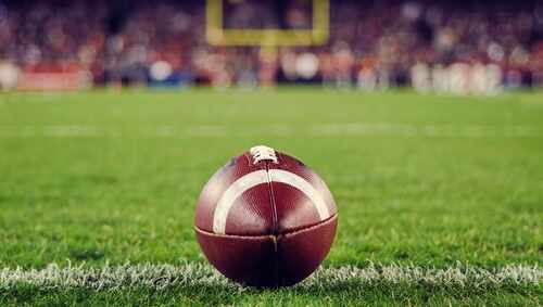 A close-up of a football on the grass field
