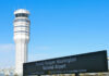 Control tower at Ronald Reagan Washington National Airport with directional sign