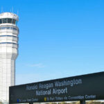 Control tower at Ronald Reagan Washington National Airport with directional sign