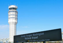 Control tower at Ronald Reagan Washington National Airport with directional sign