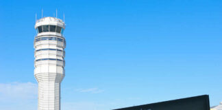 Control tower at Ronald Reagan Washington National Airport with directional sign