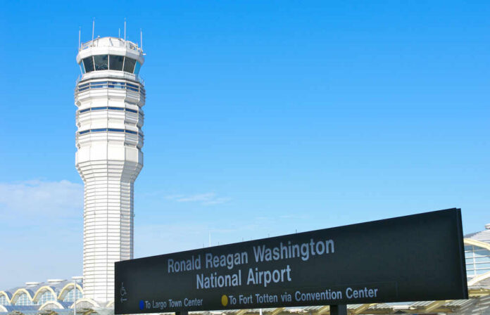 Control tower at Ronald Reagan Washington National Airport with directional sign