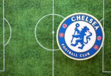 Chelsea Football Club logo on a soccer field background