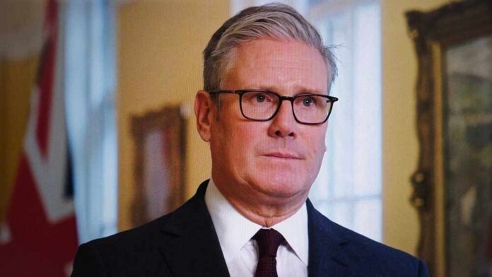 shutterstock_2686848491.jpg A man in formal attire with glasses, looking serious in an indoor setting