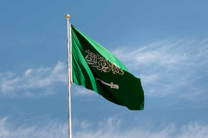 shutterstock_339172451.jpg Saudi Arabian flag waving against a blue sky