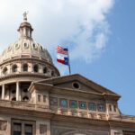 Texas State Capitol dome with American Texas flags