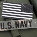 US Navy patch and black and white flag