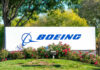 Boeing logo on sign with flowers and trees